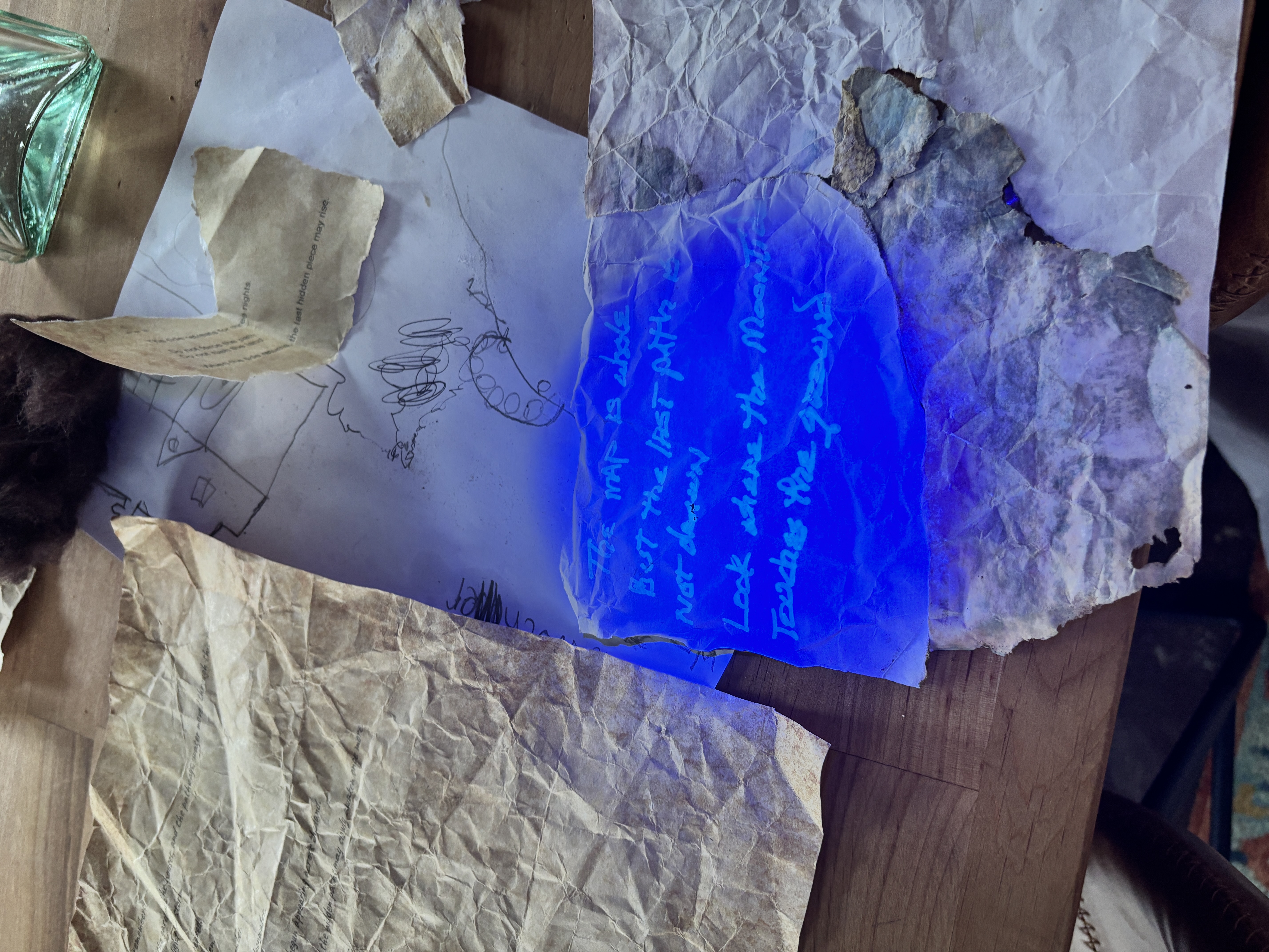 A hidden handwritten message glowing blue under ultraviolet light